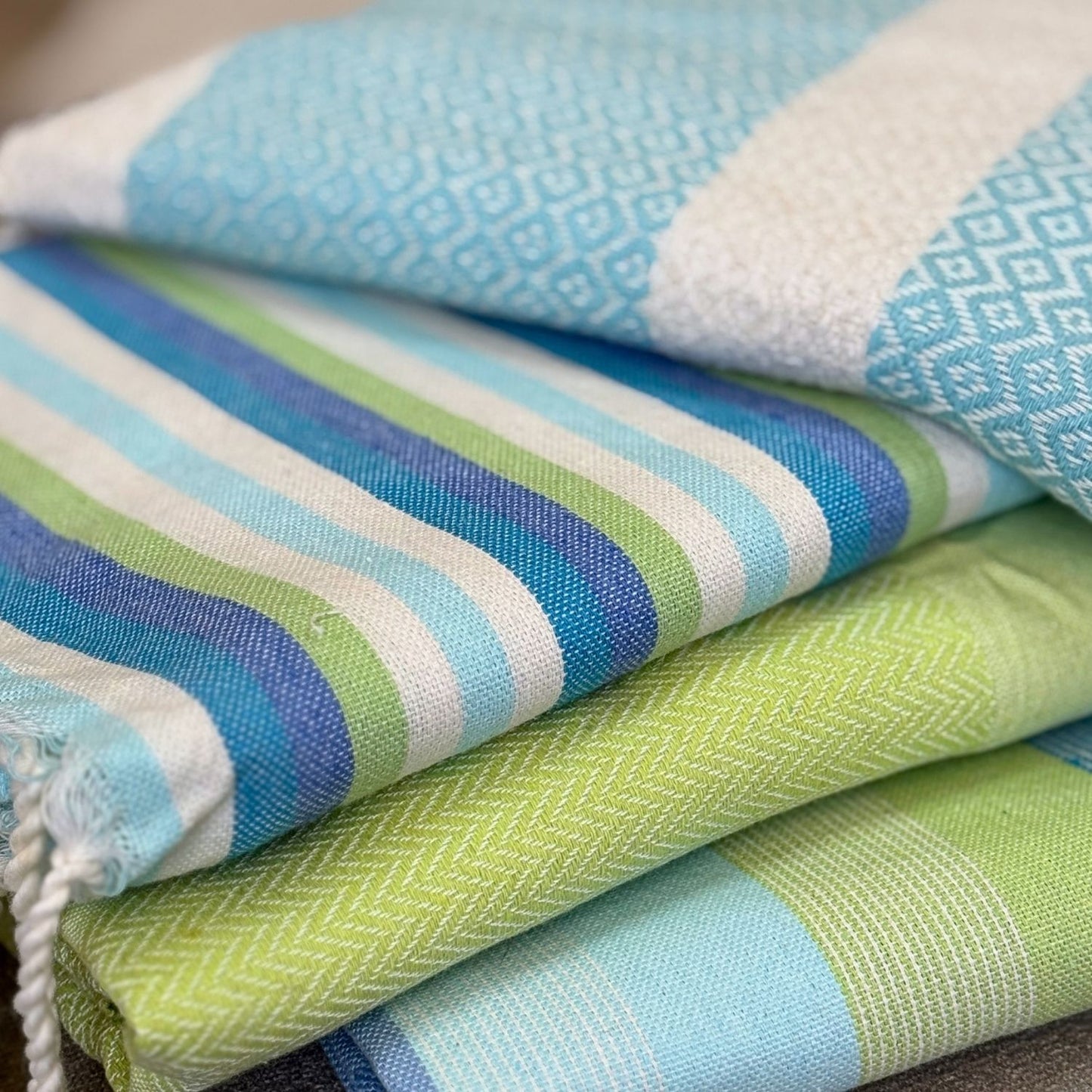 folded lime green fouta towel with tassels showing full size and woven cotton detail