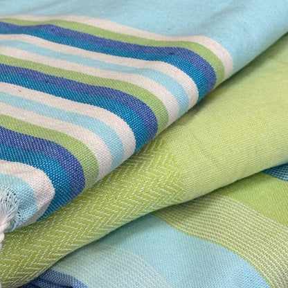 close up of lime green fouta towel fabric showing herringbone weave texture and soft cotton detail