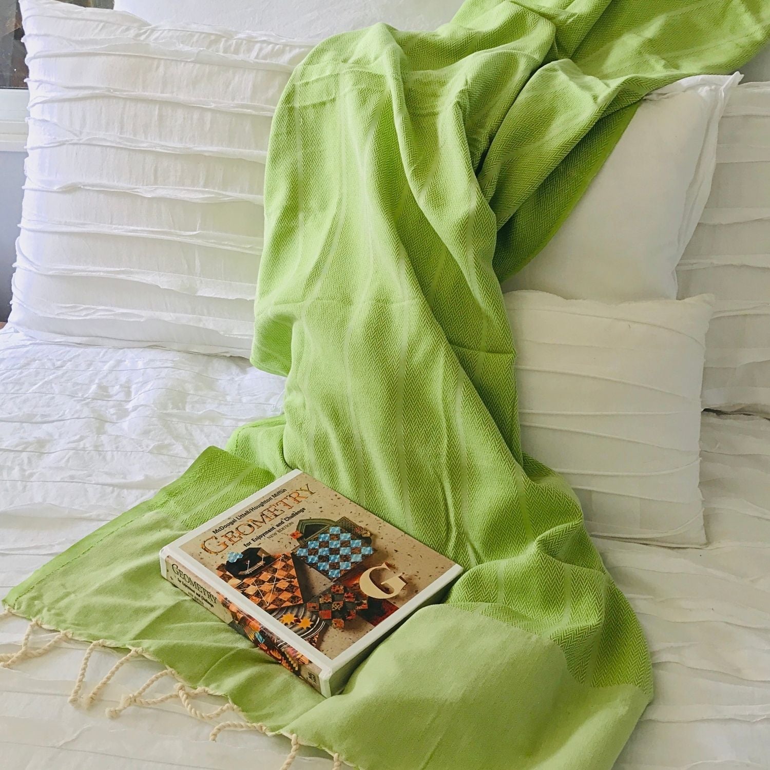 ime cotton fouta towel styled on bed with neutral pillows lightweight throw blanket for home decor